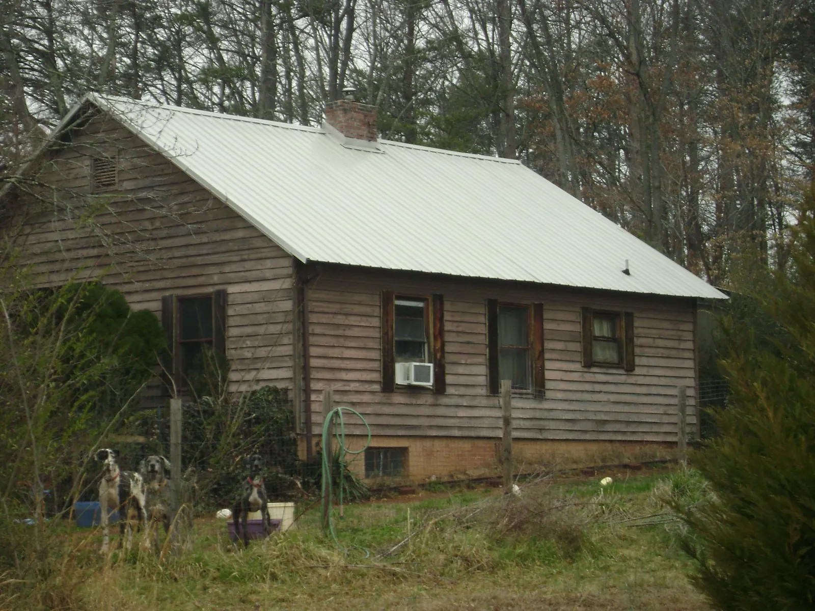 White metal roof on an old wood sided farmhouse, from a Asphalt Shingle Roof Repair job in Pearblossom
